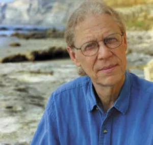 Jeremy Jackson sitting with the coastline in the background.