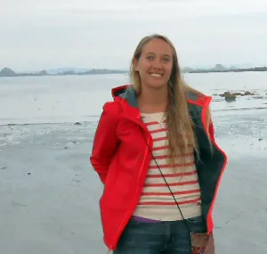 Maggie D. Johnson standing on the beach.