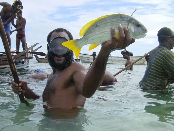 A fisherman in Papua New Guinea shows his catch for a ceremonial feast. Communities there are successfully managing their local reefs by observing temporary fishing closures that end in time to celebrate the traditional feast.