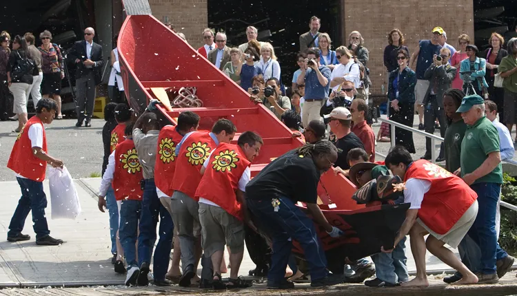 Tlingit paddlers set the canoe in Washington’s Potomac River for its ceremonial launch.