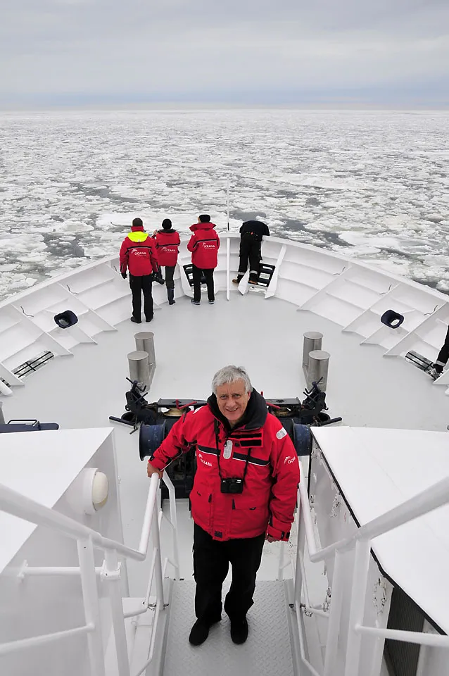 A photo of oceanographer Xavier Pastor aboard an Oceana research vessel surrounded by ice in the Baltic Sea