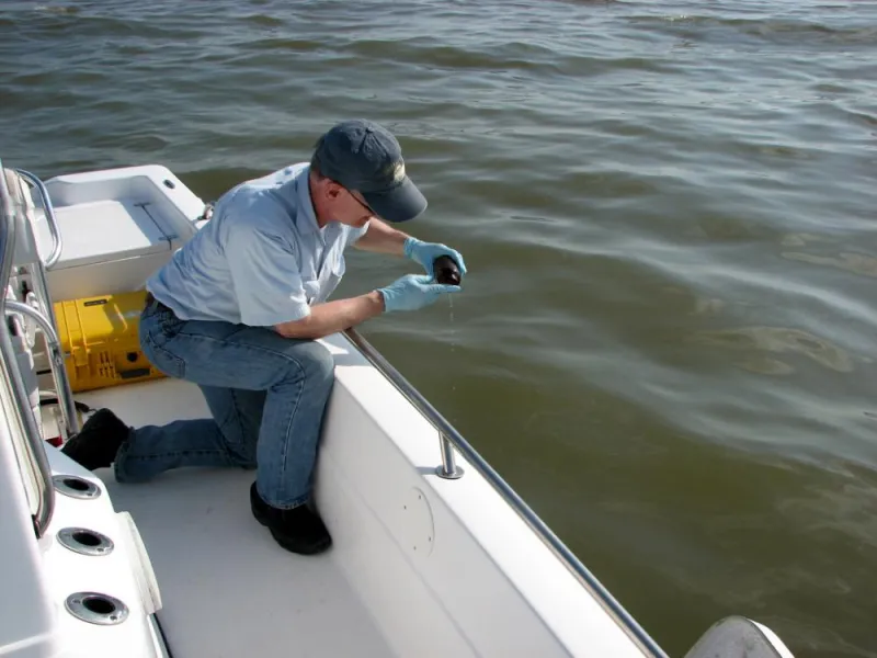 An environmental chemist collects samples of oil in the Gulf of Mexico from the Deepwater Horizon spill. The resulting chemical “fingerprint” of the oil will help determine the origin of other samples.