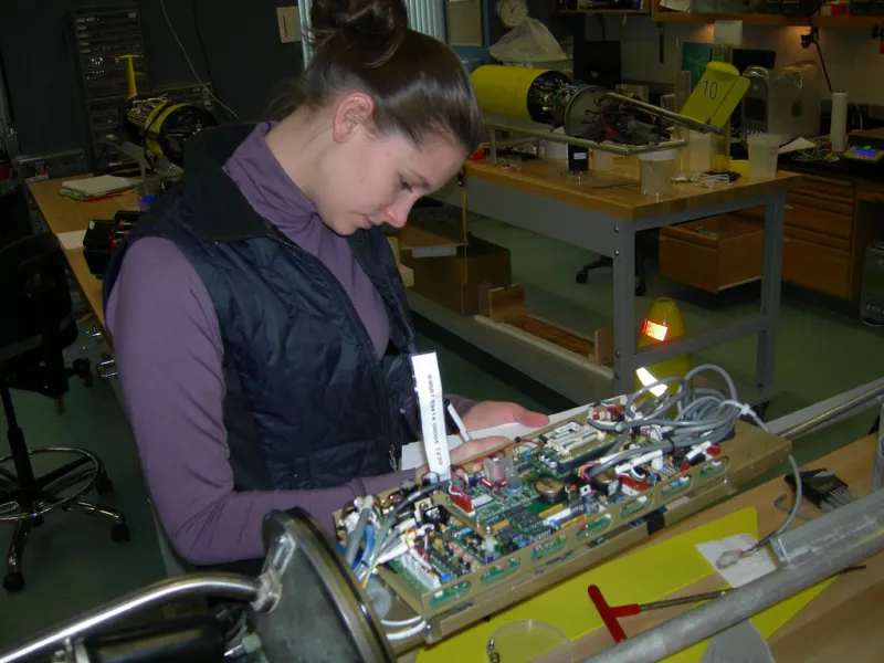 A student prepares the glider's internal electronics.