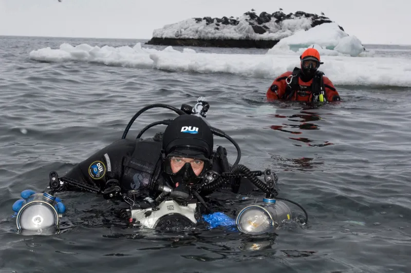 Brian Skerry prepares to dive in icy waters.