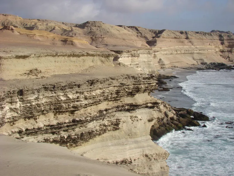 A photo of an arid ocean cliff in Chile's Atacama Desert with the ocean below.