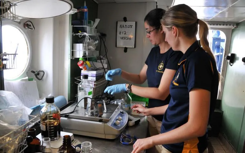 Graduate students Danielle Young from Temple University and Dannise Ruiz from Penn State preparing oil and dispersant solutions for exposure experiments with deep sea corals aboard the exploration vessel E/V Nautilus.