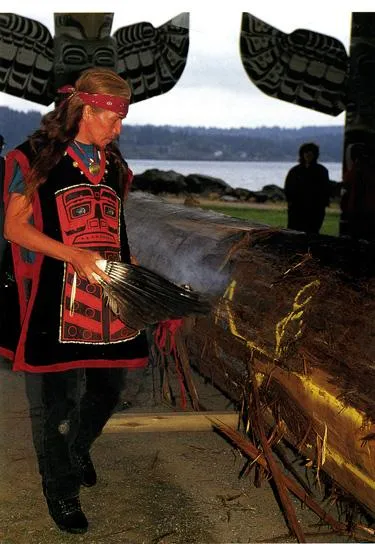 Elders bless a new canoe with lighted sage, song, and traditional dances.