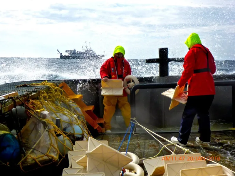 Scientists on a ship toss drifters overboard