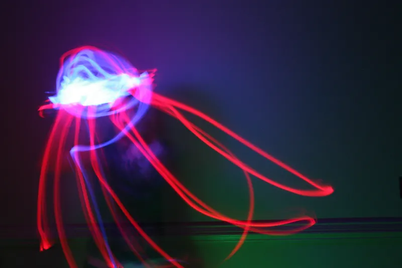 a light painted image of a red and white squid