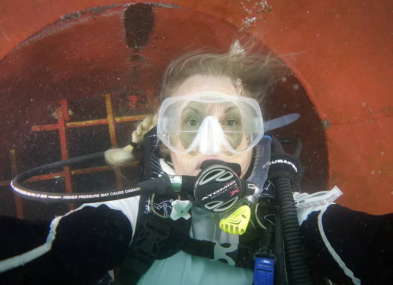 Laurie takes a break collecting invasive species to snap a "selfie" while under the hull of a cargo ship.