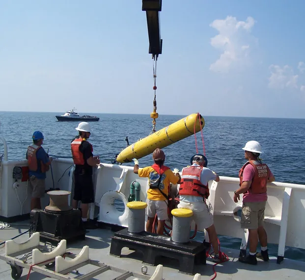 An autonomous underwater vehicle from the Monterey Bay Aquarium Research Institute (MBARI) being launched from the NOAA Ship Gordon Gunter in the Gulf of Mexico.