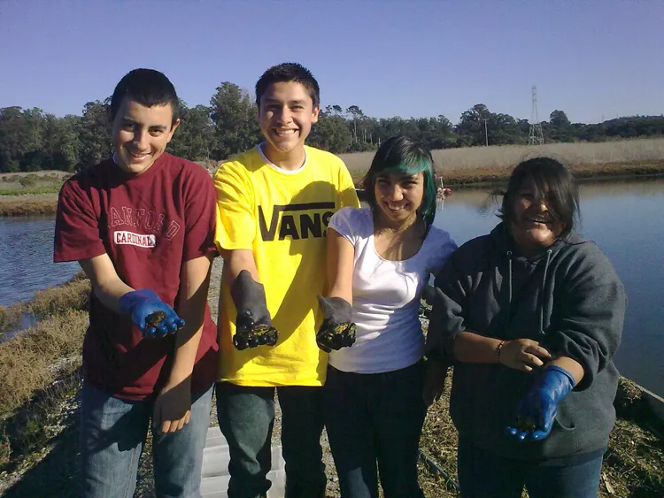 Students studying climate change and ocean acidity hold crabs.
