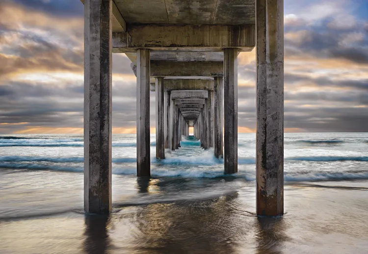 “This composition is a blend of nature and architecture. Shooting beneath the structure to get a unique perspective, I waited for days for a thick mist to lift and reveal the backlighting and color I needed to frame the pier’s converging lines. I was f