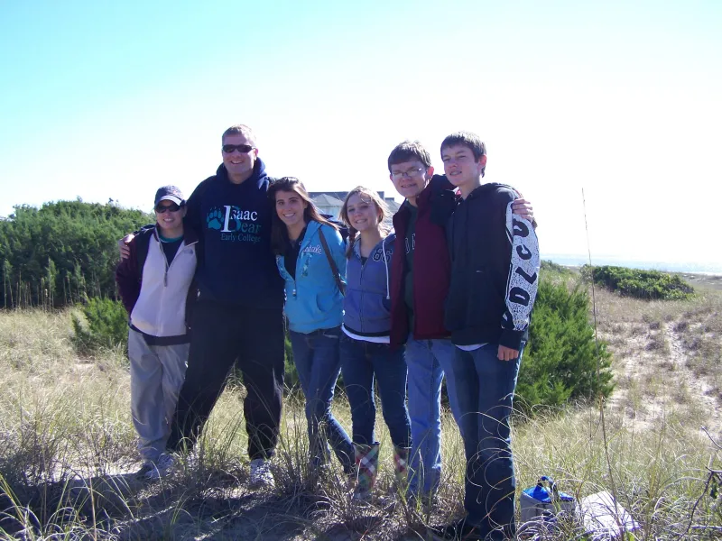 North Carolina Delegation students and teachers posing for a photo in front of the ocean at Bald Head Island in North Carolina