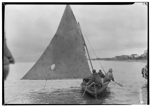 a skin boat with a sail