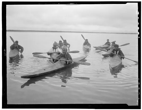 a group of men in kayaks
