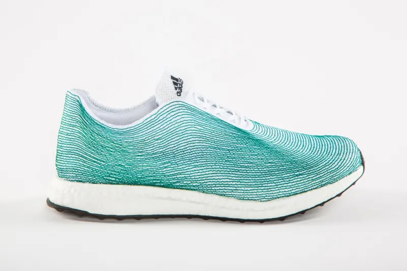 A turquoise and white adidas sneaker made of recycled ocean plastic. 