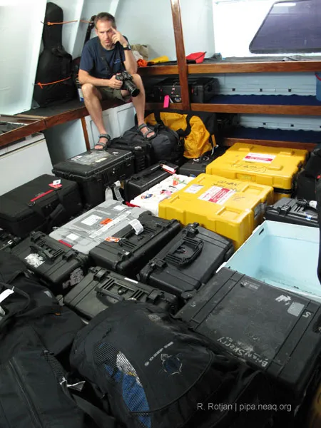 Brian Skerry in a room with all his photography equipment cases.