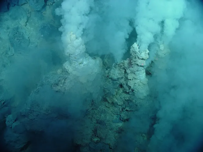 towers spew white smoke underwater