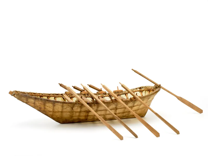 a skin boat model with oars
