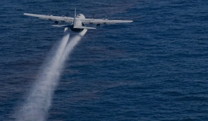 A jet drops dispersant onto the Gulf oil slick.