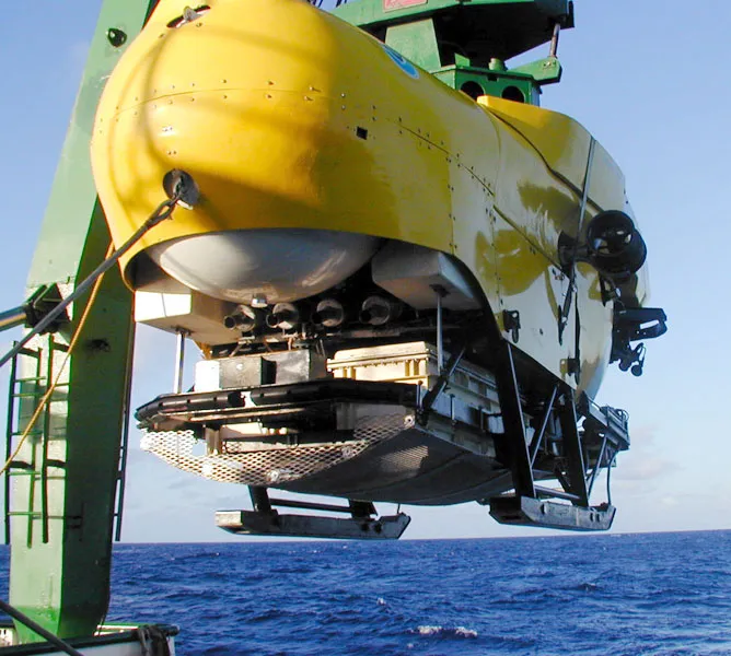 The Hawaii Undersea Research Laboratory’s Pisces V submersible is lowered for a dive to study deep-sea corals.