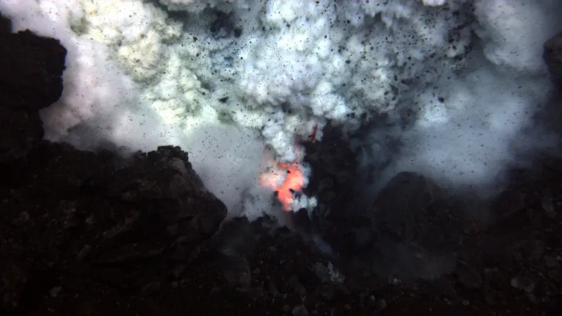 Red hot magma and ash erupt from an underwater volcano.