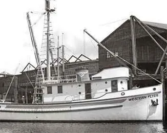 Black and white image of the Western Flyer boat at dock.