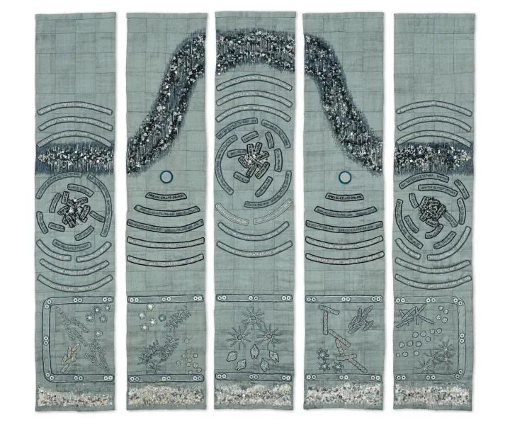 a wave is embroidered with beads and underneath copepods are embroidered in silk