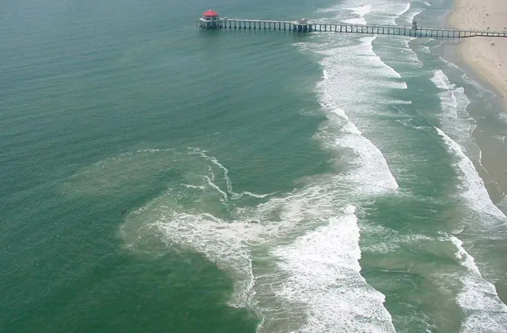 a rip current along a beach with a pier