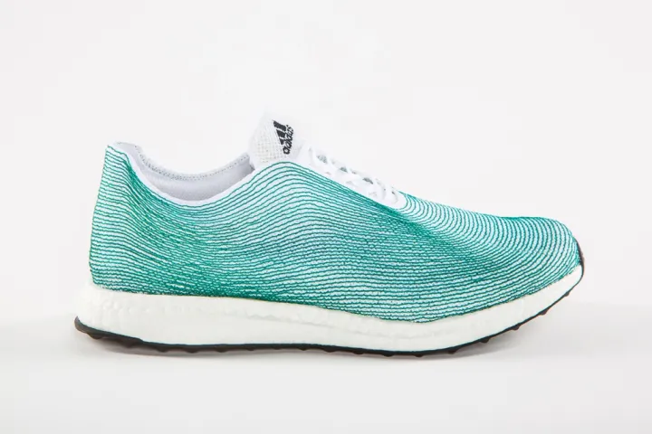 A turquoise and white adidas sneaker made of recycled ocean plastic. 