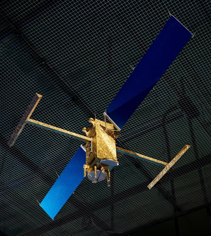 a satellite model hangs from the ceiling