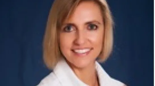 Melanie McField smiling at the camera in a headshot
