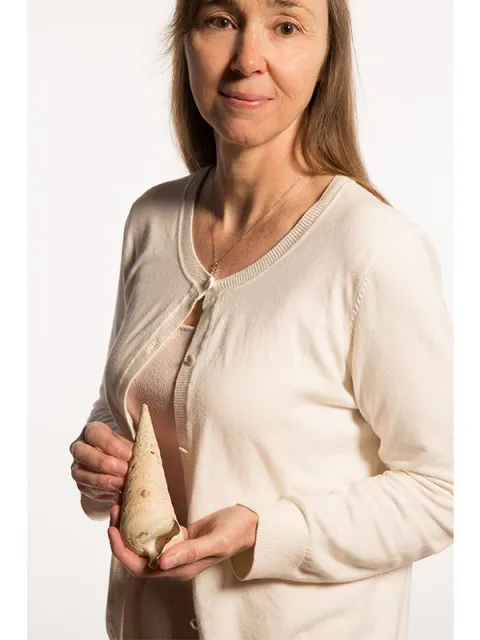 a woman holding a snail